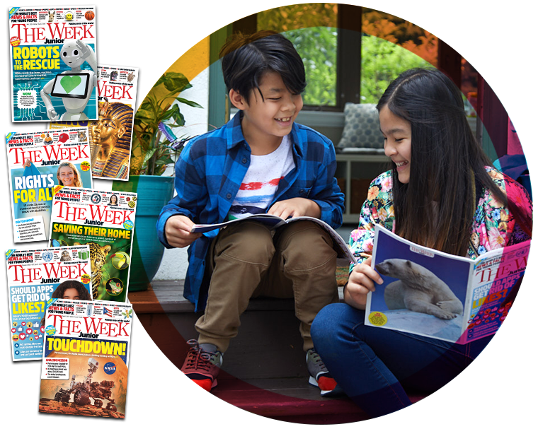 Boy and girl sitting next to each other, reading The Week Junior and smiling